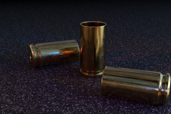Empty Pistol Casings on Asphalt